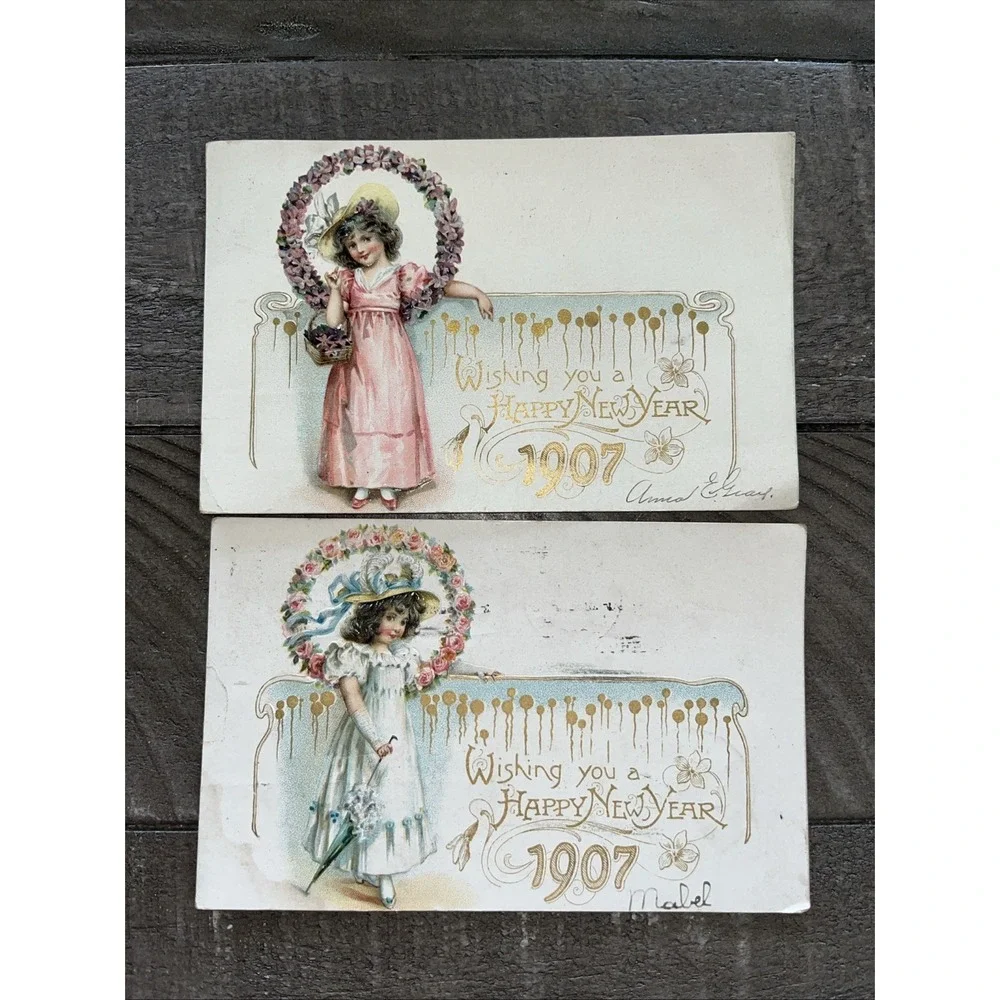 1907 Girl Violet Flowers Pink Dress, Girl Blue Dress New Year Tucks Postcard
